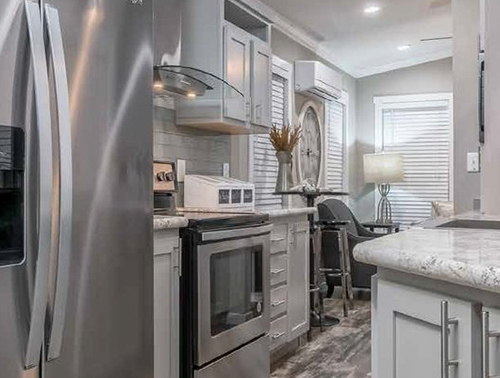 Modern tiny home kitchen with stainless steel appliances