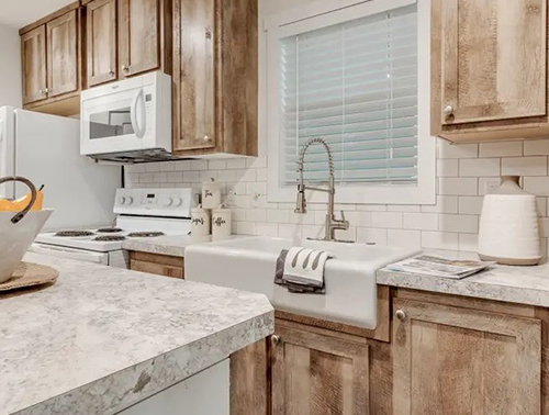 Tiny home kitchen with wood cabinets and countertops